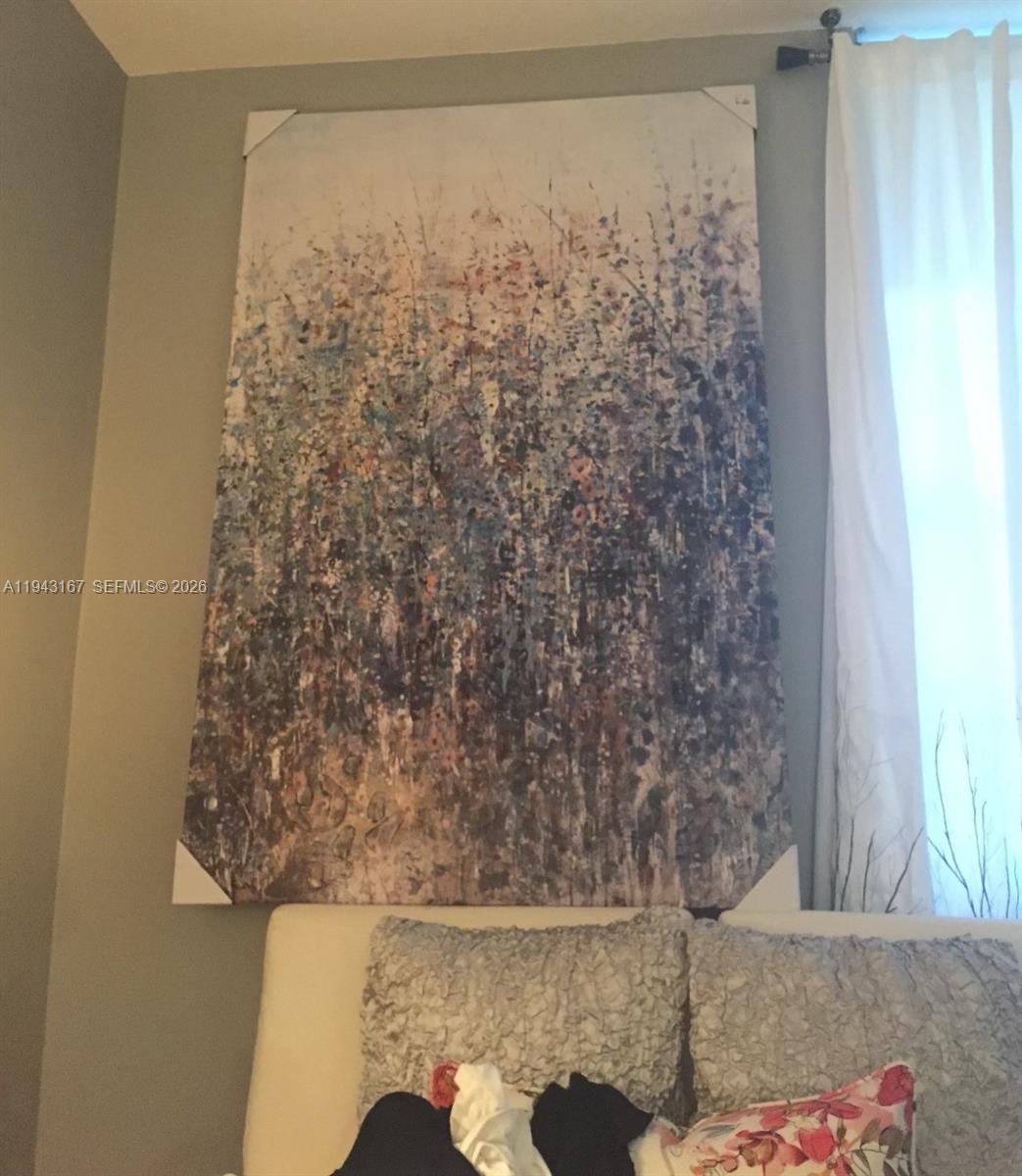 A large abstract floral canvas painting hangs on a wall above a white sofa — 100 Lincoln Rd # 814, Miami Beach FL 33139, MIAMI BEACH, FL