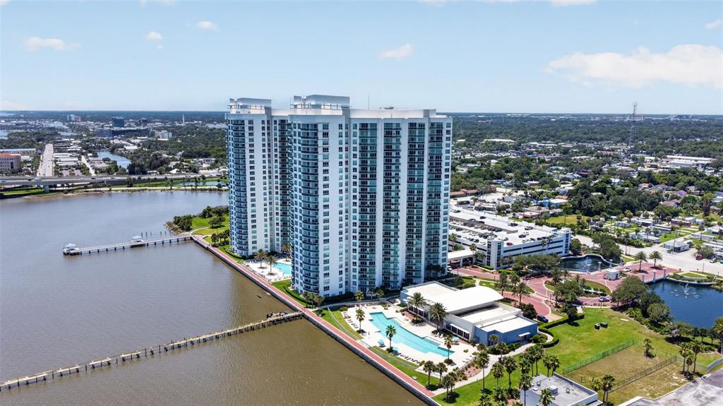 An aerial view shows a tall residential building complex with a pool and a pier — 231 RIVERSIDE DRIVE UNIT 1108-1, HOLLY HILL, FL