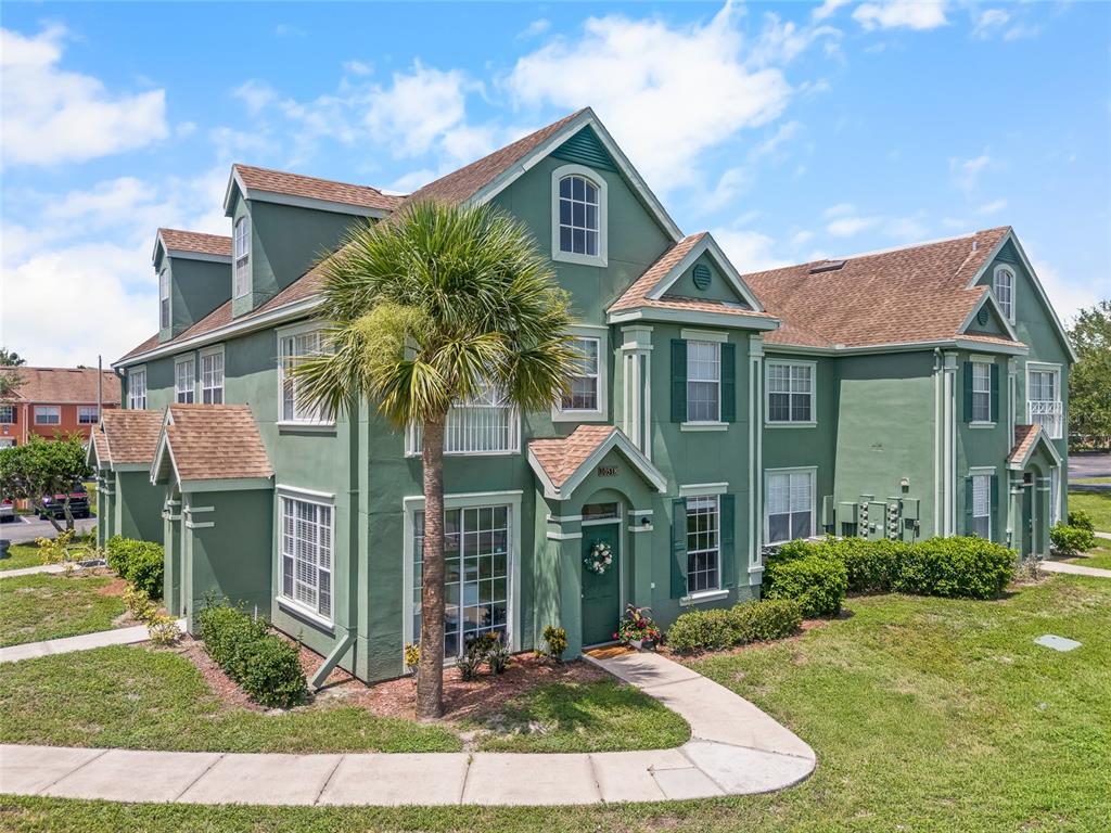 A two-story green apartment building with a brown shingled roof and a palm tree — 10518 WHITE LAKE COURT UNIT 10518, TAMPA, FL
