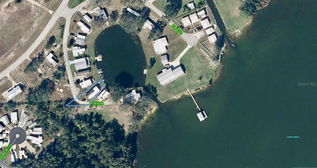 This aerial map shows residential properties situated along a small pond and Lake Grassy — 16 W PALM CIRCLE, LAKE PLACID, FL