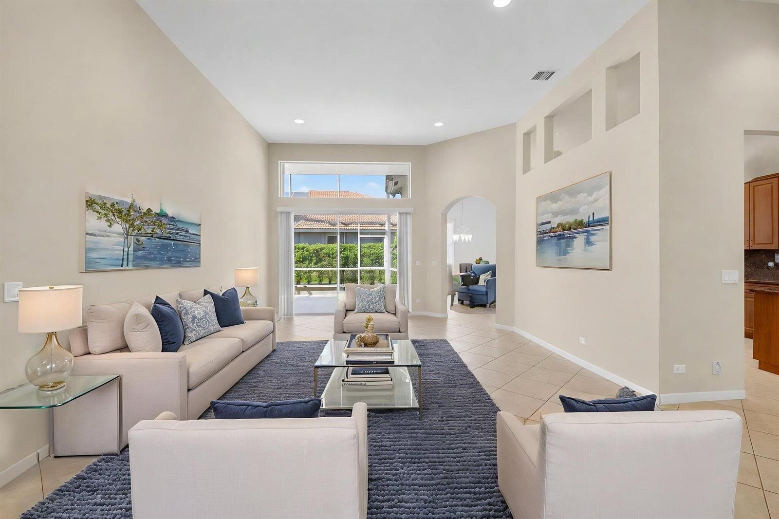 A living room features a beige sofa, two armchairs, a glass coffee table, and tile flooring — 7713 Rinehart Drive, Boynton Beach FL 33437, BOYNTON BEACH, FL