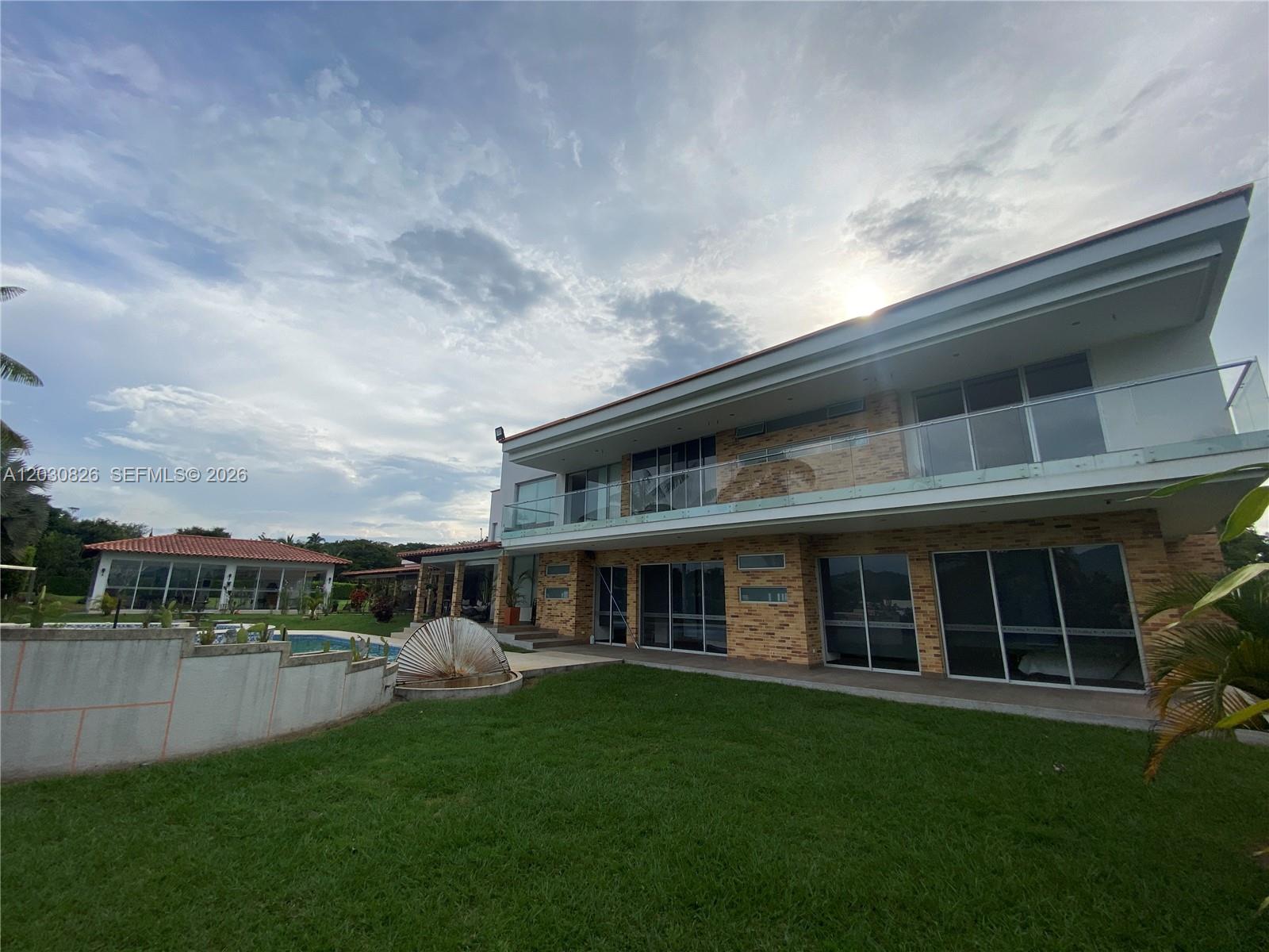 A two-story modern house with brick siding, glass balconies, and a backyard swimming pool — Sector Pavas Malabar Conjunto Chambery Casa 11, 0, FL