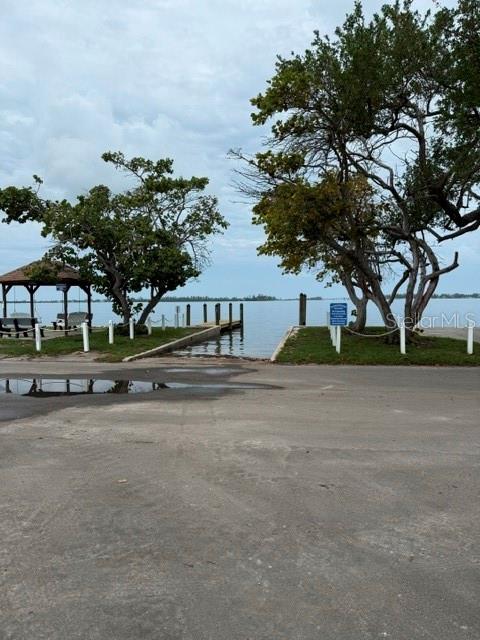 A boat ramp leads into the water between two large trees and a wooden pavilion — 4519 106TH STREET W, BRADENTON, FL