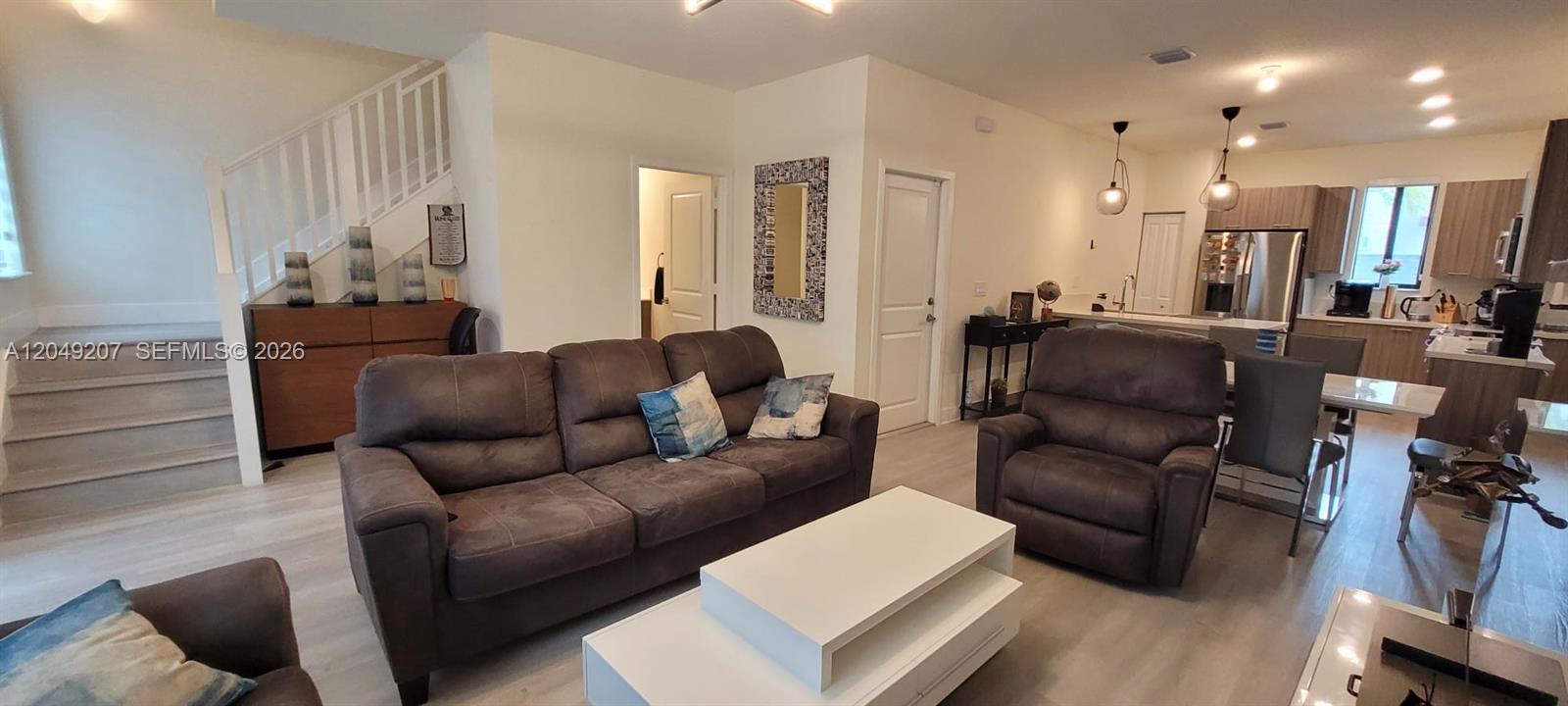 A living room features a grey sofa, a recliner, and a white coffee table — 4682 NW 83rd Ave, Doral FL 33166, DORAL, FL