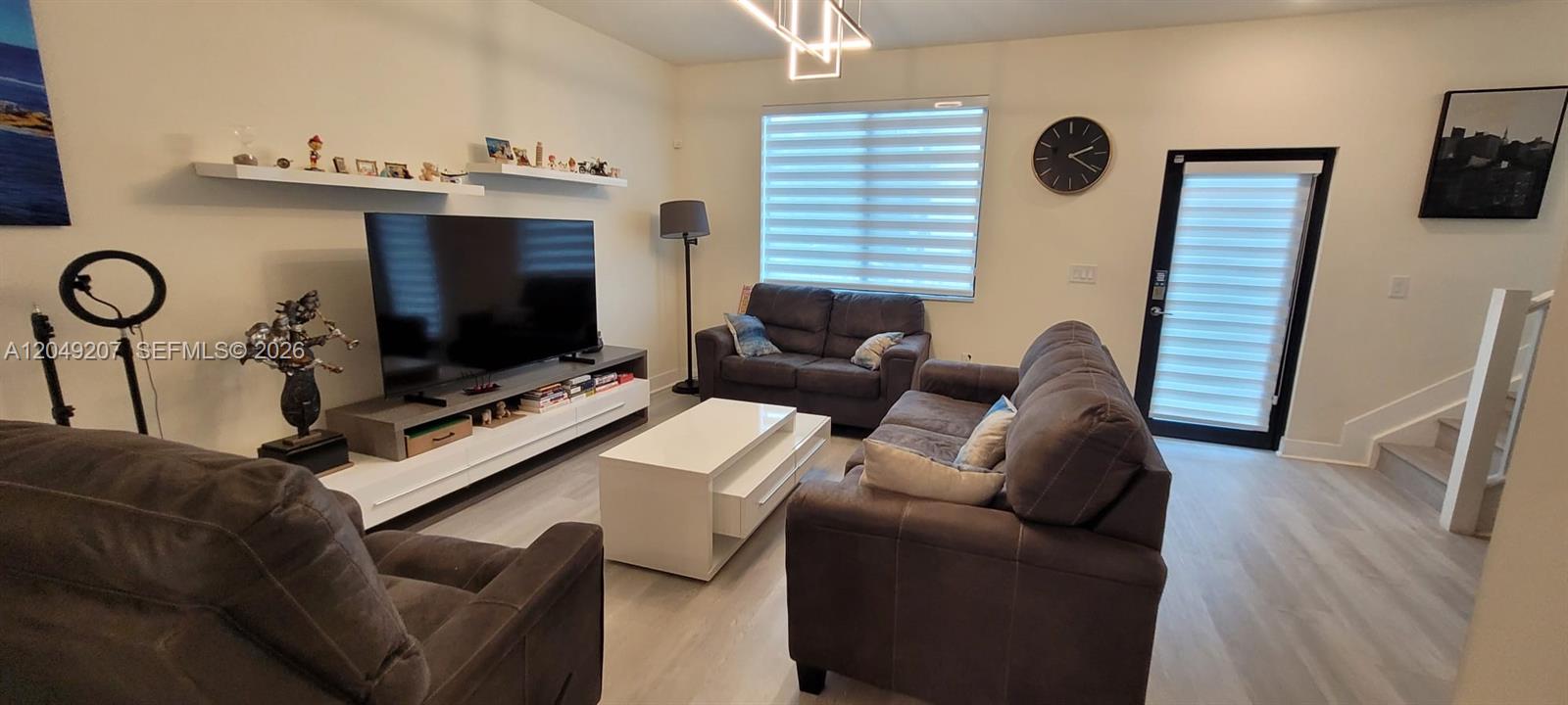 A living room features gray sofas, a white coffee table, and a television console — 4682 NW 83rd Ave, Doral FL 33166, DORAL, FL