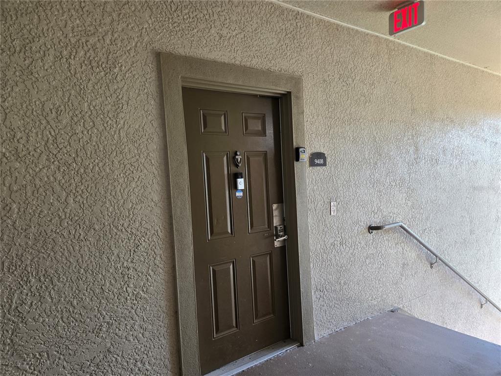 A brown apartment door with a smart lock and unit number 9408 on a textured wall — 1301 TUSCAN TERRACE UNIT 9408, DAVENPORT, FL
