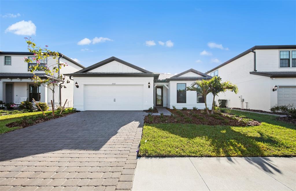 A white single-story house with a two-car garage and a paved driveway — 2657 GABEL OAK DRIVE, NORTH PORT, FL
