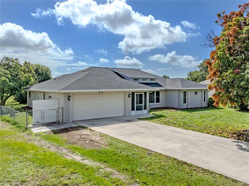 An aerial view shows a single-story house with a gray shingled roof and a driveway — 364 SAN AMBROSIO STREET, PUNTA GORDA, FL