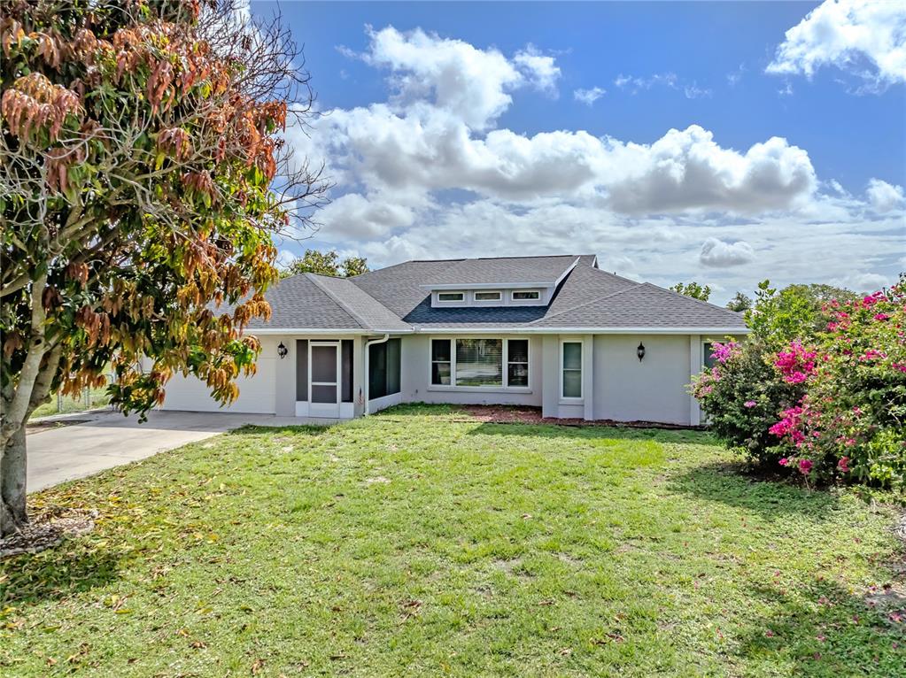 A single-story house with a gray roof, light-colored exterior, and a front lawn — 364 SAN AMBROSIO STREET, PUNTA GORDA, FL