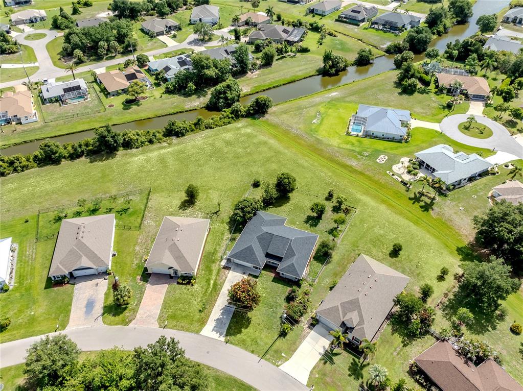 An aerial view shows a single-story house with a fenced backyard and surrounding residential neighborhood — 364 SAN AMBROSIO STREET, PUNTA GORDA, FL