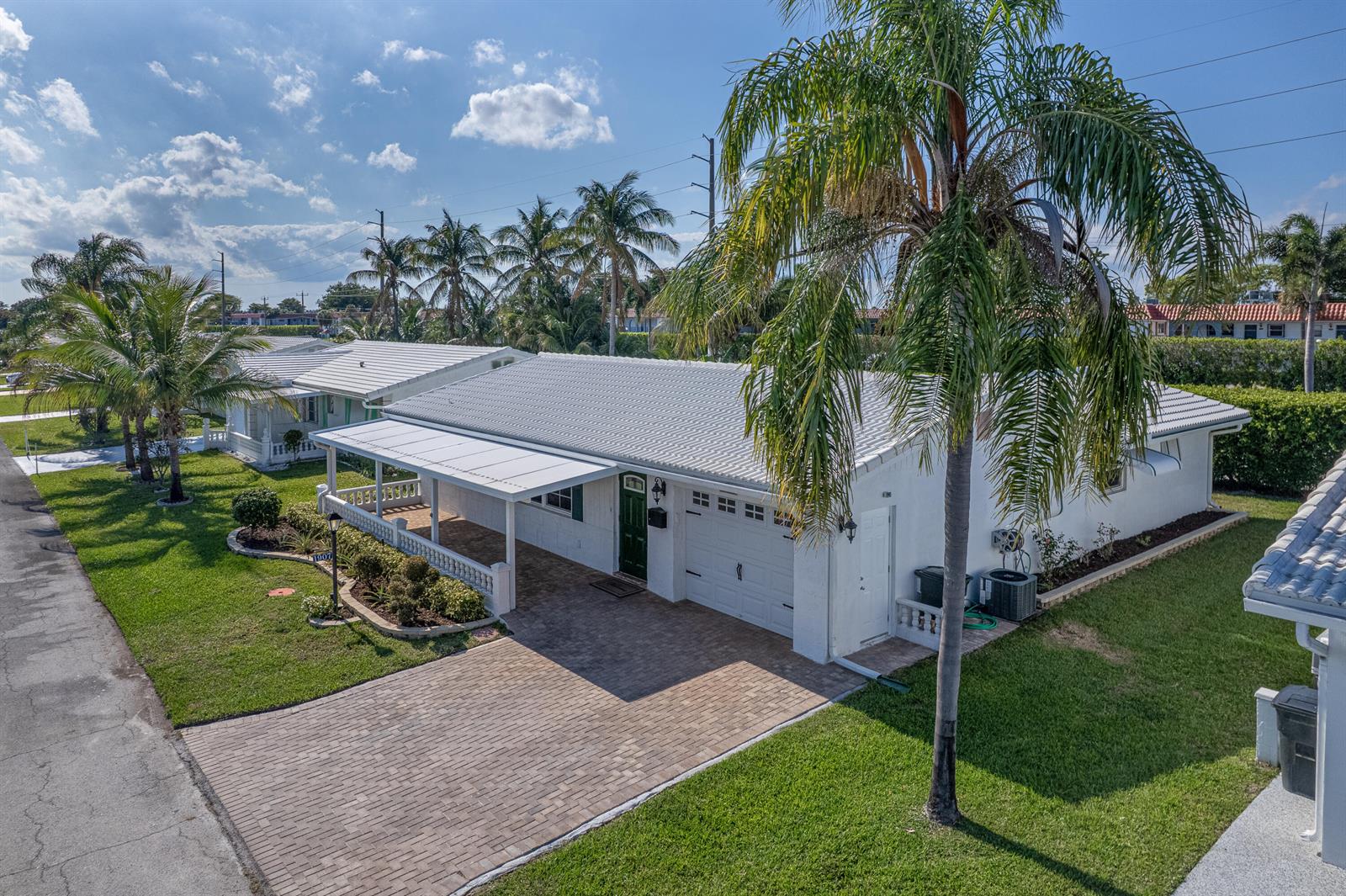 An aerial view shows a white single-story house with a tiled roof and paved driveway — 1907 SW 16th Avenue, Boynton Beach FL 33426, BOYNTON BEACH, FL
