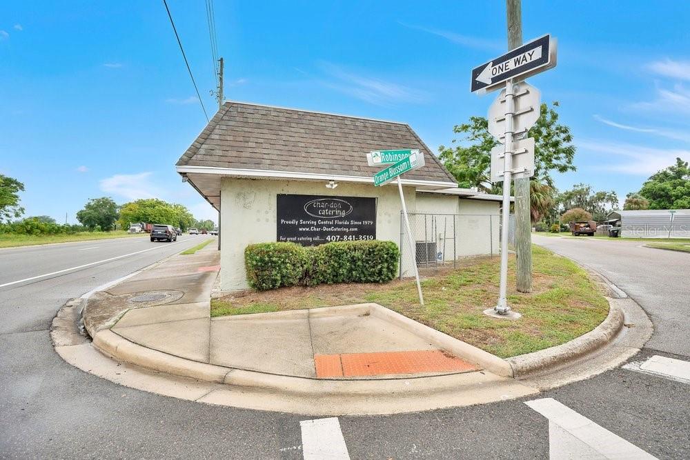 An exterior view of a catering business building located at a street corner intersection — 3101 N ORANGE BLOSSOM TRAIL, ZELLWOOD, FL
