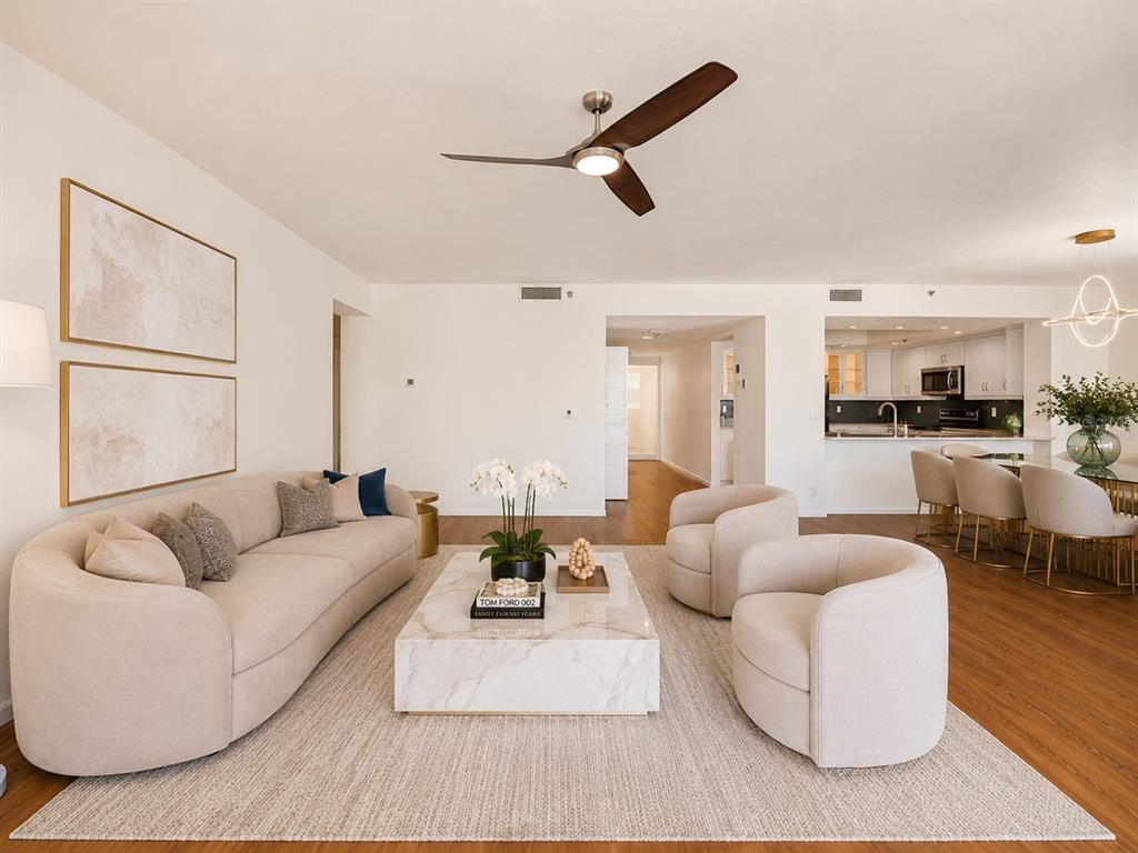 A living room with a beige sofa, two armchairs, and a marble coffee table — 1255 N GULFSTREAM AVENUE UNIT 1101, SARASOTA, FL