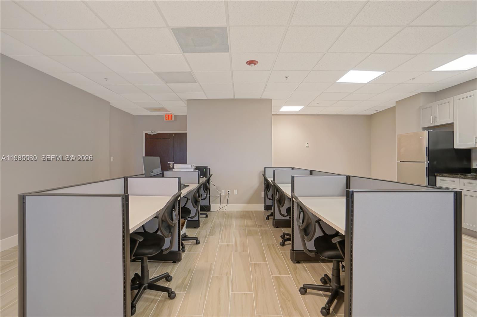 An office space features rows of cubicles with desks, chairs, and a small kitchenette area — 12550 Biscayne Blvd # 902, North Miami FL 33181, NORTH MIAMI, FL