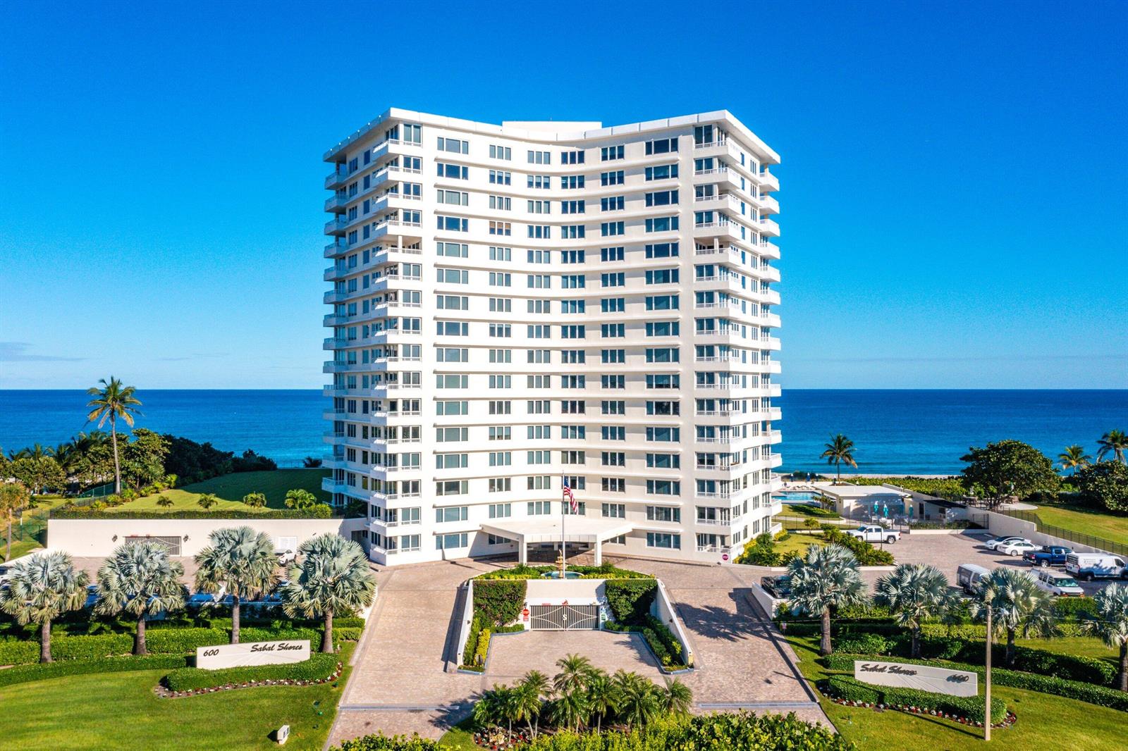 An aerial view of a tall white residential building with balconies overlooking the ocean — 600 S Ocean Boulevard # 504, Boca Raton FL 33432, BOCA RATON, FL