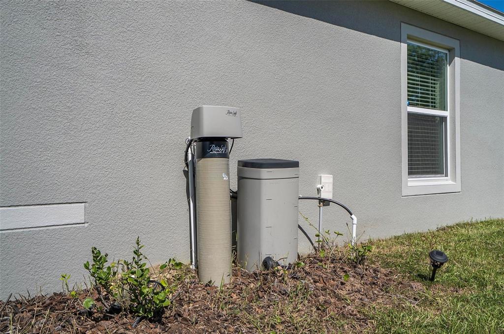 A RainSoft water treatment system is installed against the exterior wall of a house — 38 PRETORIA LANE, PALM COAST, FL