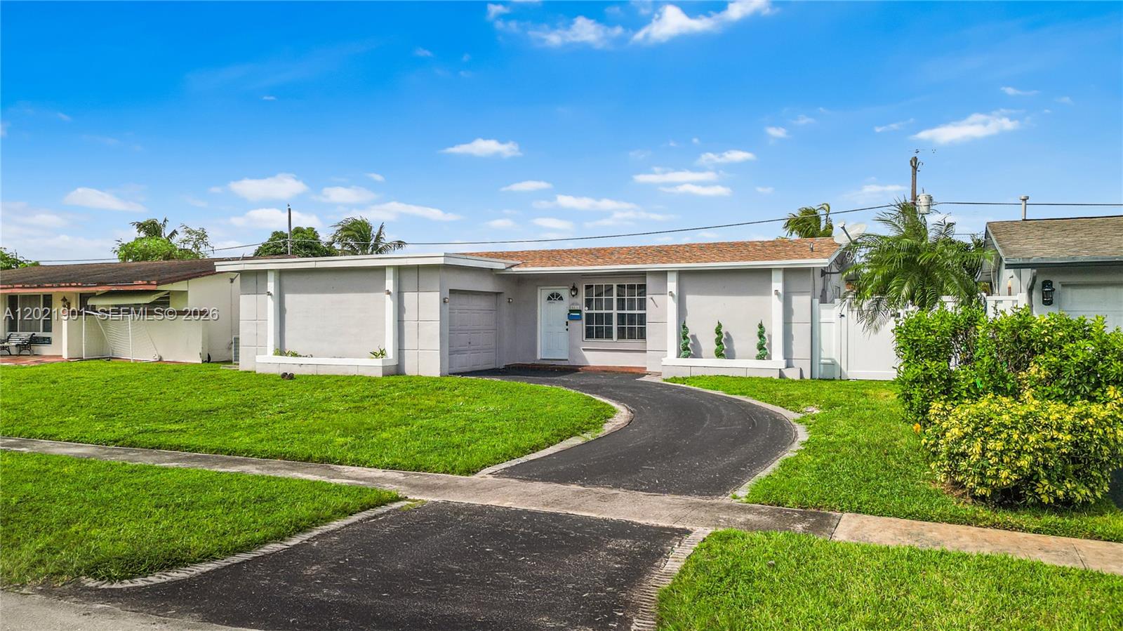 A single-story house with a curved driveway, a white front door, and a grassy lawn — 8531 NW 25th St, Sunrise FL 33322, SUNRISE, FL