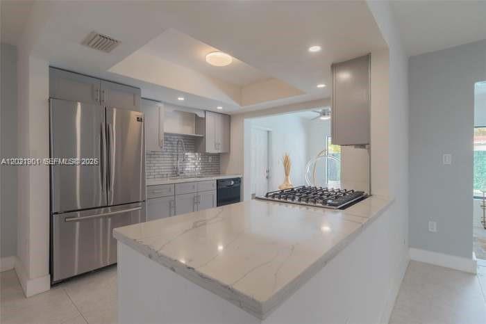A modern kitchen features stainless steel appliances, grey cabinetry, and a white marble-patterned countertop — 8531 NW 25th St, Sunrise FL 33322, SUNRISE, FL