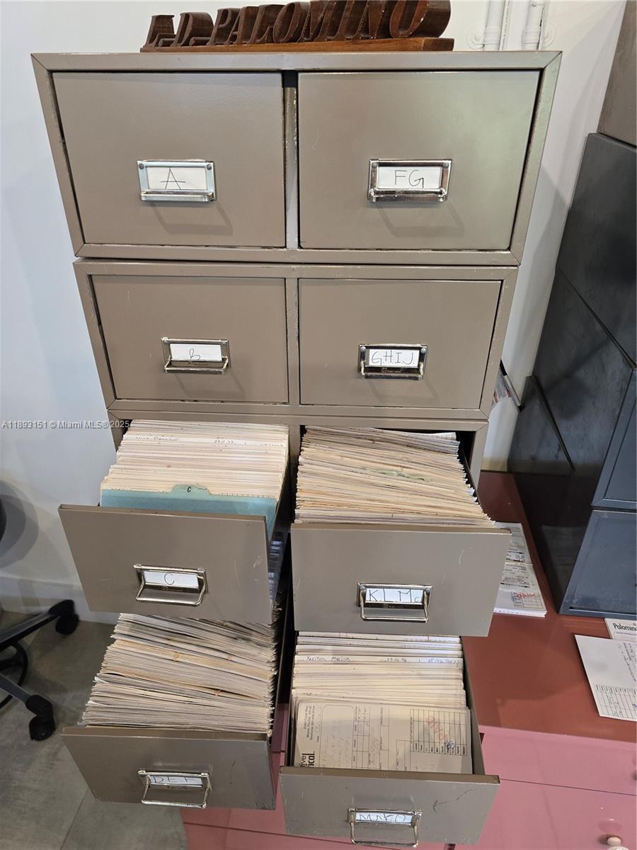 A metal filing cabinet with labeled drawers stands in an office space — 2100 Coral Way, Coral Gables FL 33145, CORAL GABLES, FL