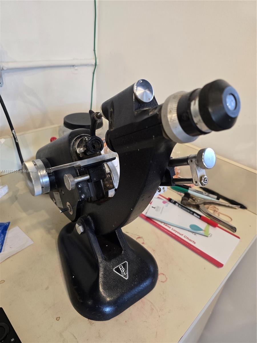 A vintage Bausch & Lomb lensometer sits on a white desk in an office space — 2100 Coral Way, Coral Gables FL 33145, CORAL GABLES, FL