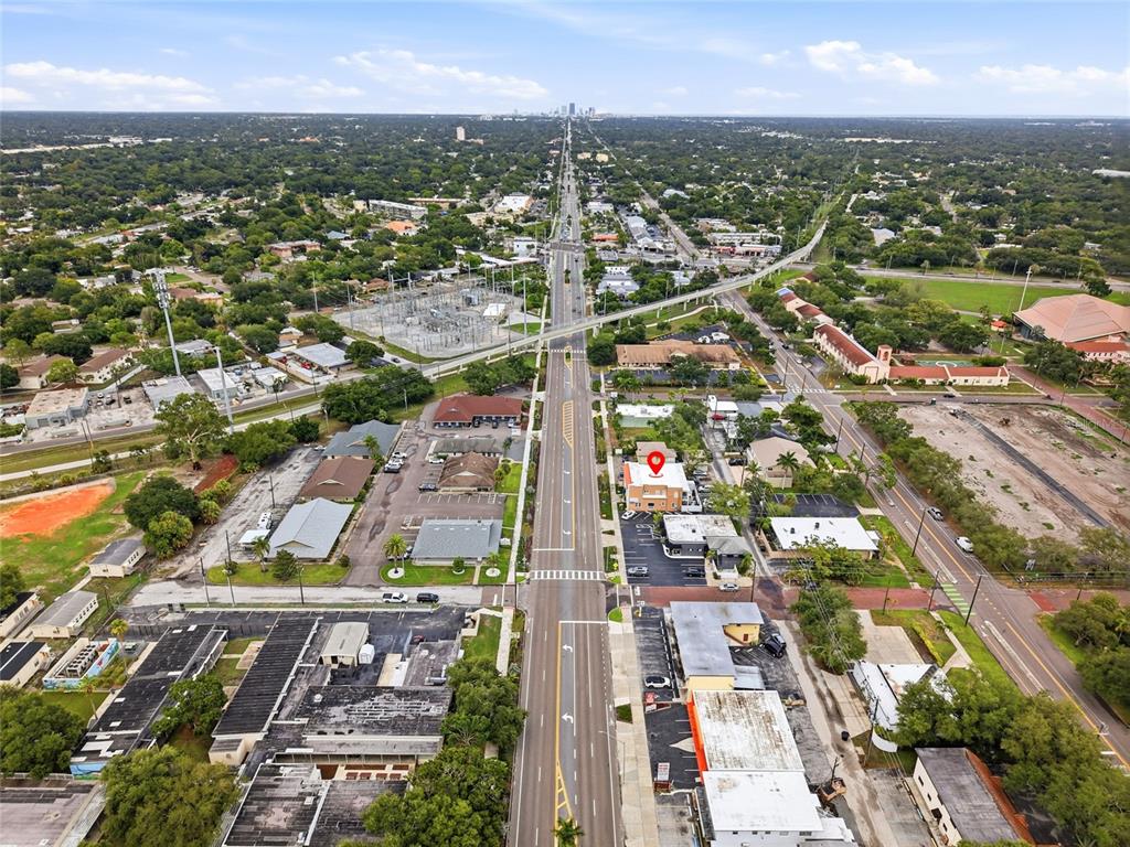 An aerial view shows a commercial building with a red location pin on a street — 7024 CENTRAL AVENUE, ST PETERSBURG, FL