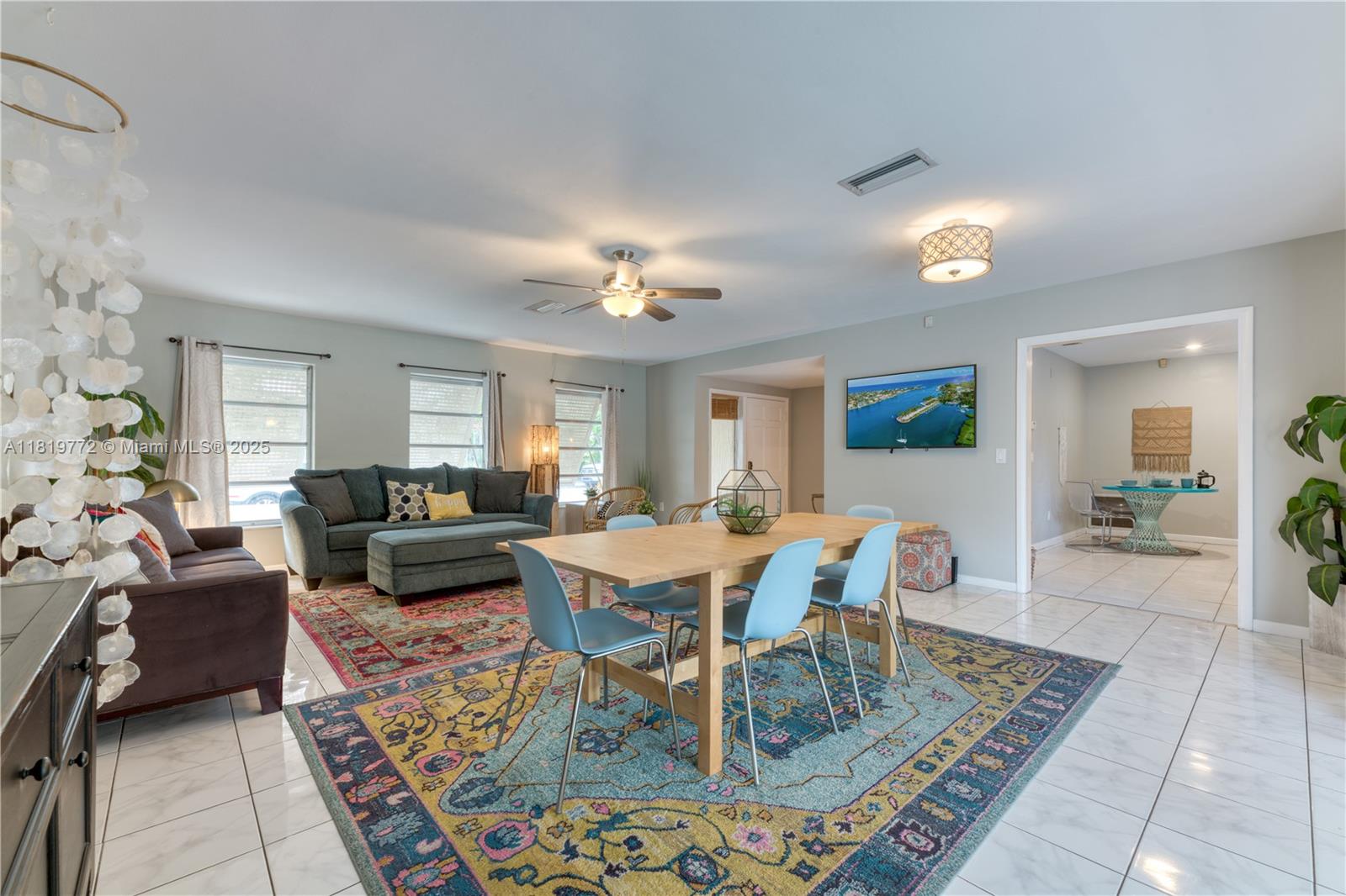 A living and dining area features tile floors, a large patterned rug, and blue chairs — 1122 S N St, Lake Worth FL 33460, LAKE WORTH, FL