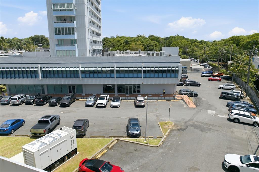 An elevated view shows a multi-story office building with a large parking lot in front — 501 CENTRO ALTAMIRA, CALLE PERSEO UNIT 501, SAN JUAN, PR