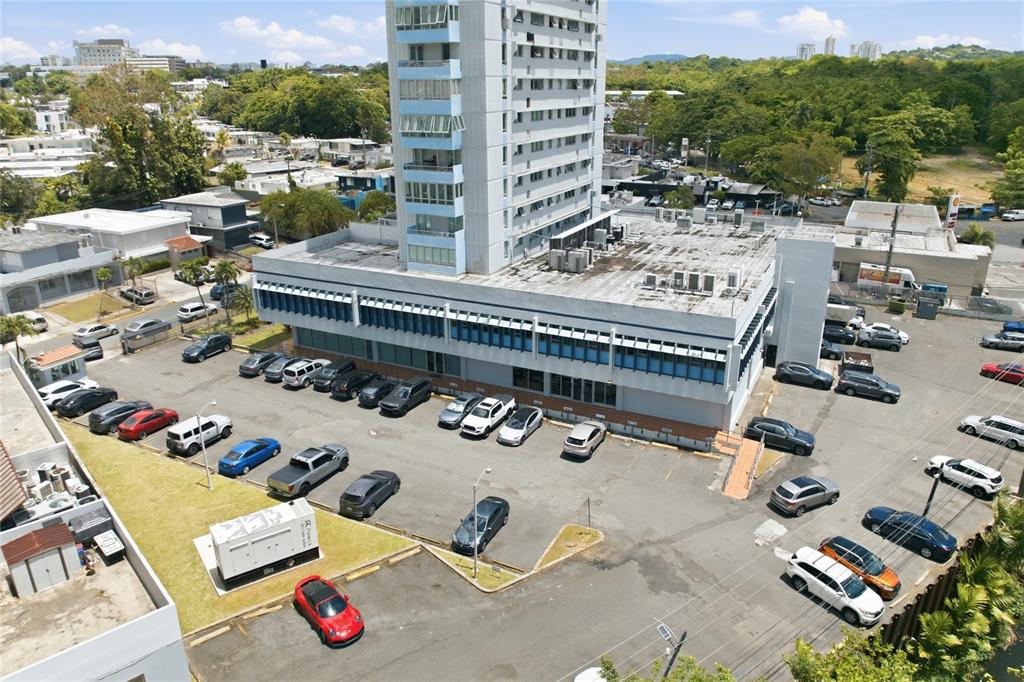 An aerial view shows a tall office building with a large parking lot — 501 CENTRO ALTAMIRA, CALLE PERSEO UNIT 501, SAN JUAN, PR