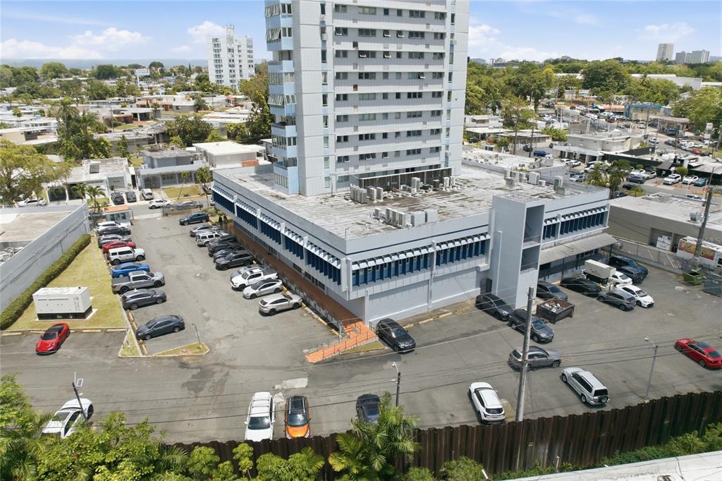An aerial view shows a tall office building with a large parking lot — 501 CENTRO ALTAMIRA, CALLE PERSEO UNIT 501, SAN JUAN, PR