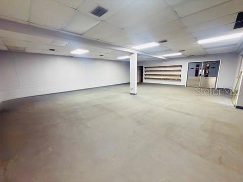An empty commercial space with gray walls, a concrete floor, and a drop ceiling — 1185 GOODEN CROSSING UNIT A, LARGO, FL