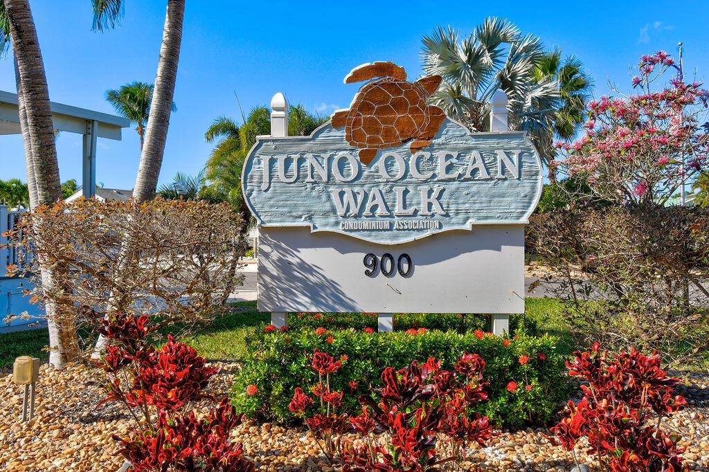 A sign for Juno Ocean Walk Condominium Association stands in a landscaped garden — 900 Juno Ocean Walk, Juno Beach FL 33408, JUNO BEACH, FL