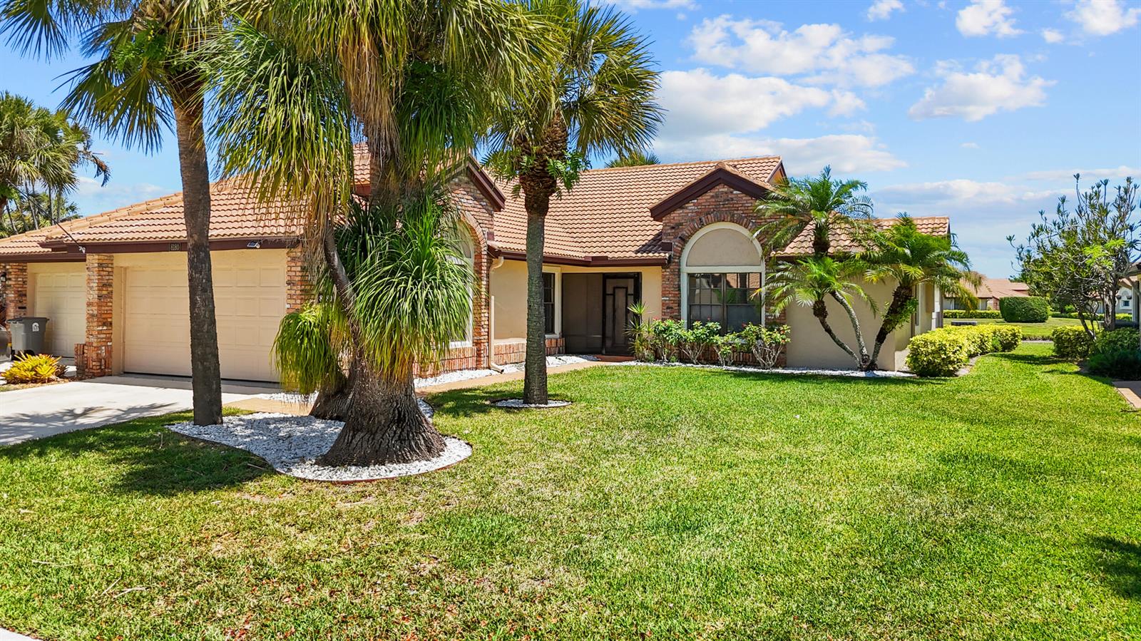 A single-story brick house with a tile roof and palm trees in the front yard — 8180 Bellwort Place, Boynton Beach FL 33472, BOYNTON BEACH, FL
