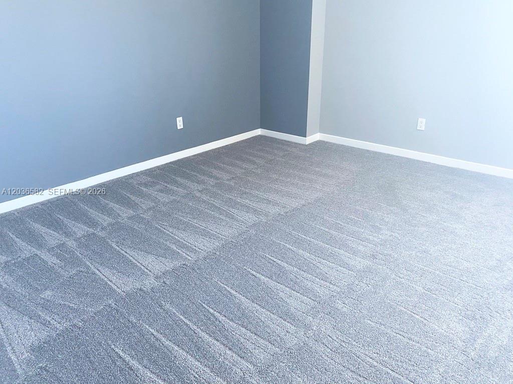 This room features gray walls, white baseboards, and patterned gray wall-to-wall carpeting — 335 BISCAYNE BL # 4200, Miami FL 33131, MIAMI, FL
