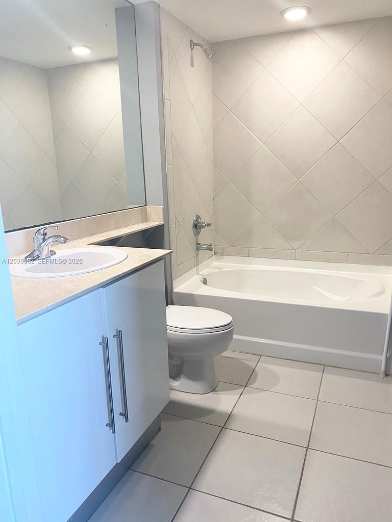 A bathroom features a white vanity, a toilet, and a tiled shower-tub combination — 335 BISCAYNE BL # 4200, Miami FL 33131, MIAMI, FL