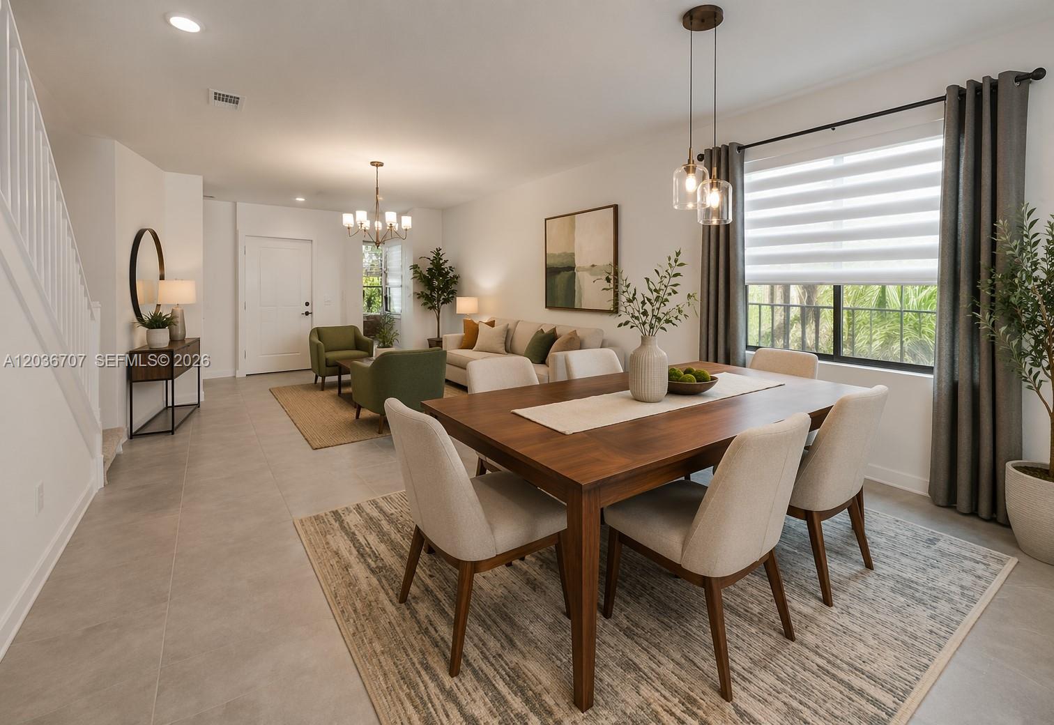 A living room features a white sofa, green armchairs, a staircase, and a console table — 20900 NE 2nd Ct, Miami FL 33179, MIAMI, FL