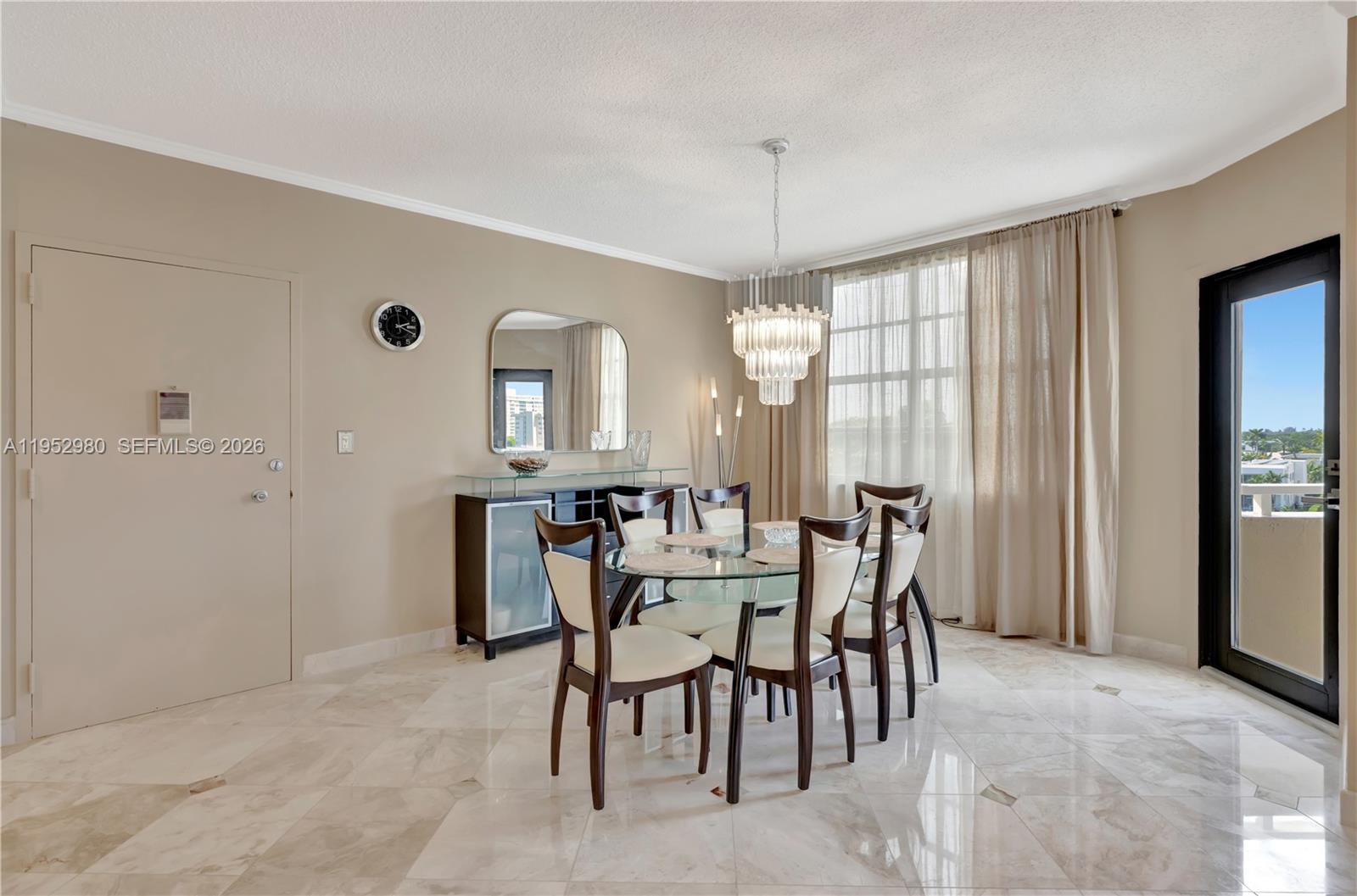 A dining room features a glass table, six chairs, a chandelier, and marble flooring — 1965 S Ocean Dr # 4S, Hallandale Beach FL 33009, HALLANDALE BEACH, FL