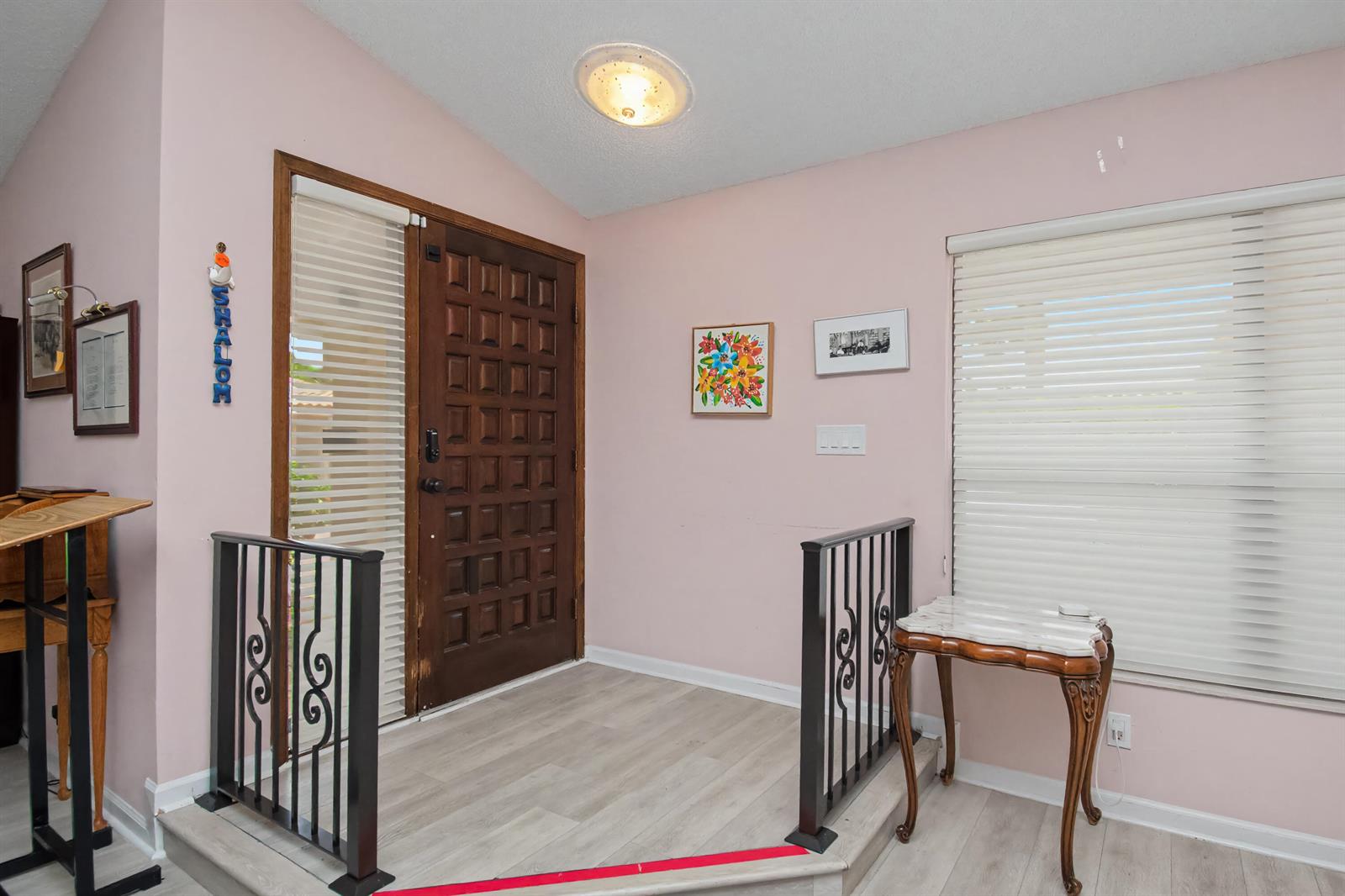 An entryway features a raised landing, a wooden front door, and black metal railings — 7986 Palacio Del Mar Drive, Boca Raton FL 33433, BOCA RATON, FL