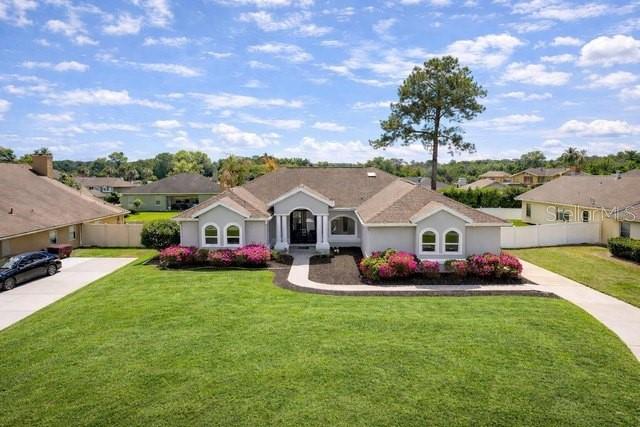 A single-story house with a gray exterior, a brown roof, and a large front lawn — 1088 SW 32ND LANE, OCALA, FL