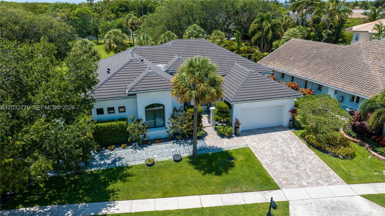 An aerial view shows a single-story house with a dark tiled roof and a paved driveway — 1755 SW 4th Ave, Boca Raton FL 33432, BOCA RATON, FL