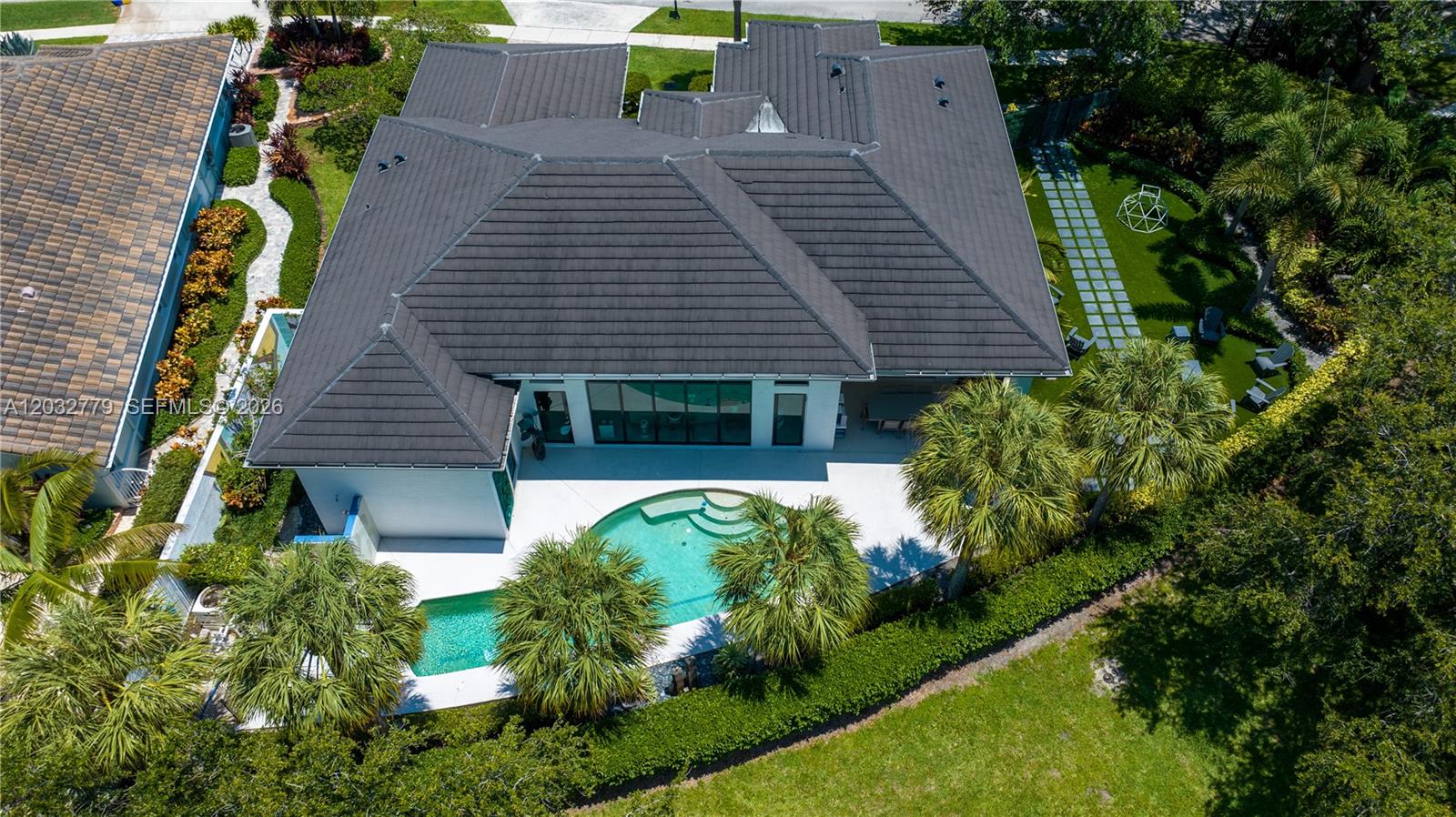 An aerial view shows a house with a dark tiled roof, a swimming pool, and landscaping — 1755 SW 4th Ave, Boca Raton FL 33432, BOCA RATON, FL