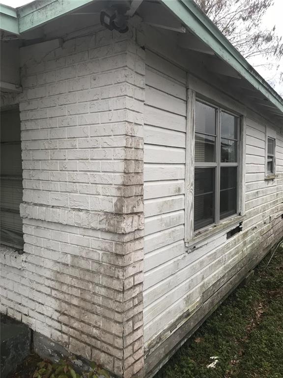 An exterior view of a house corner featuring white-painted brick and horizontal wood siding — 2340 BROADWAY STREET, SANFORD, FL