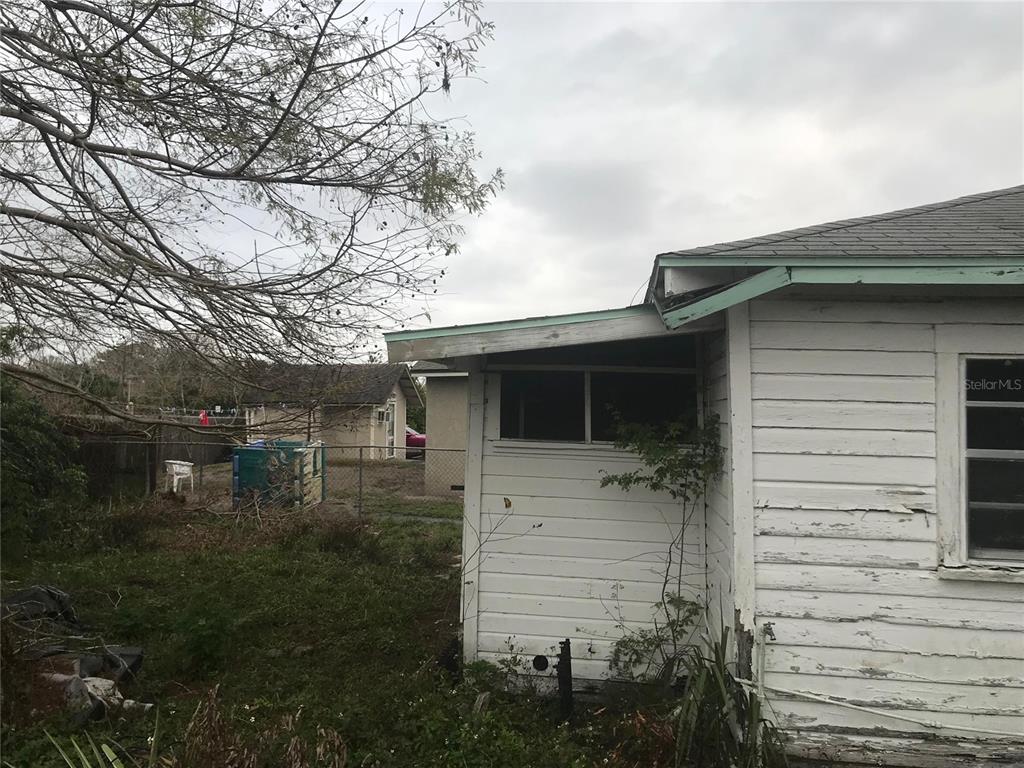 An exterior view of a white wood-sided house with a weathered roof and yard — 2340 BROADWAY STREET, SANFORD, FL