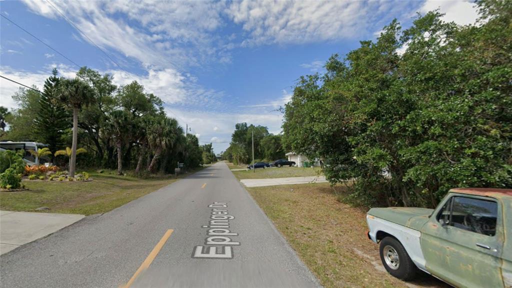 A street view shows a paved road named Eppinger Dr with trees and a parked truck — 1367 EPPINGER DRIVE, PORT CHARLOTTE, FL