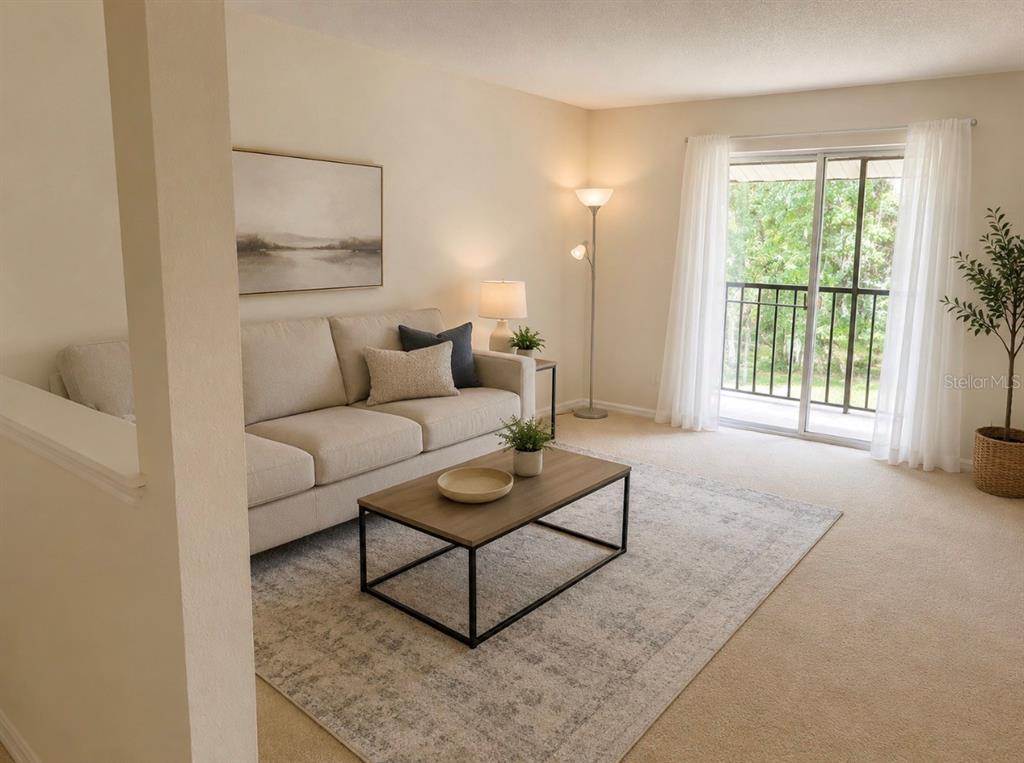 A living room features a beige sofa, a coffee table, and a sliding glass door — 4312 HECTOR COURT UNIT 4, ORLANDO, FL