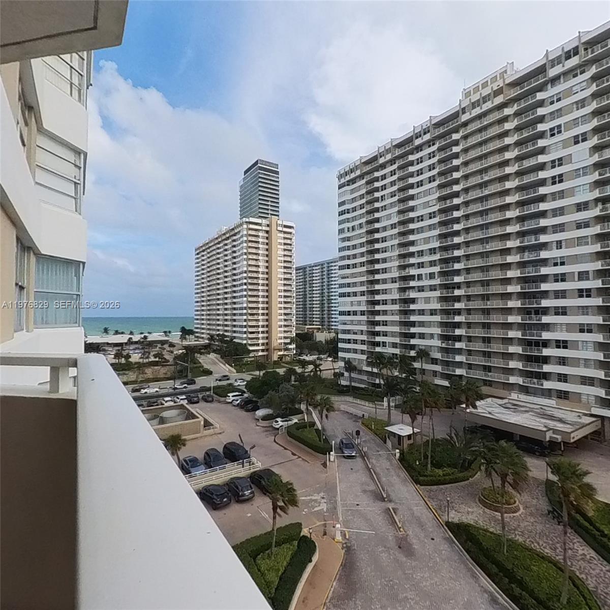 A high-angle view shows a parking lot and driveway between several large residential buildings — 1965 S Ocean Dr # 7E, Hallandale Beach FL 33009, HALLANDALE BEACH, FL