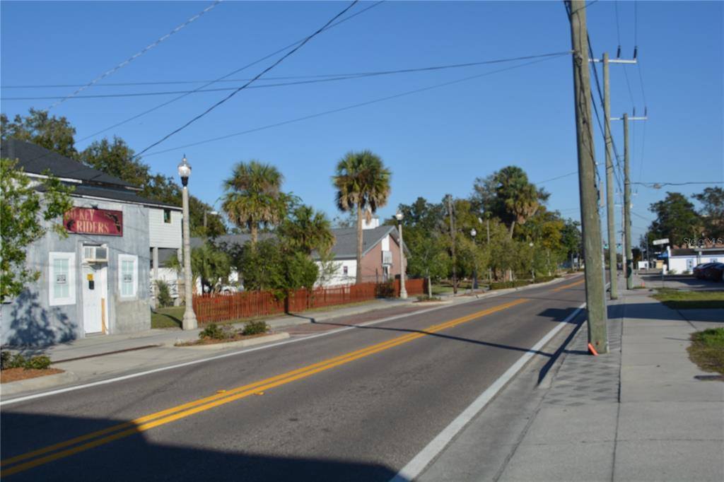 A street view shows a paved road, utility poles, palm trees, and a small building — 1006 S HISTORIC GOLDSBORO, SANFORD, FL