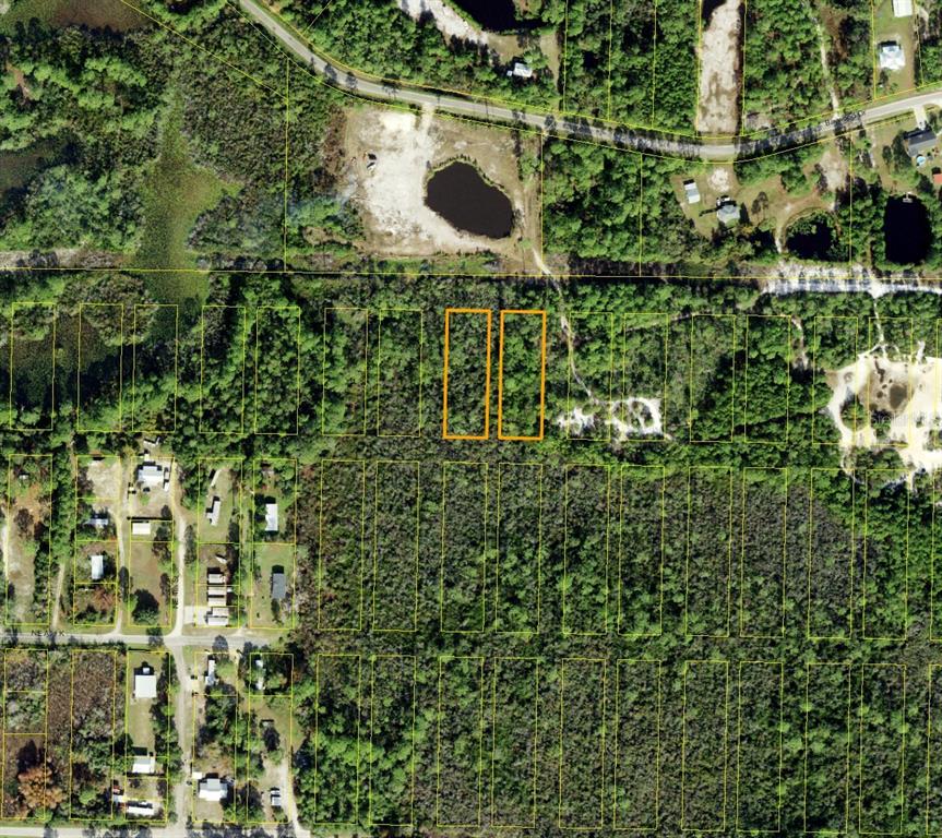 This aerial map shows two highlighted adjacent rectangular plots of land in a wooded area — 000 BAYWOOD DRIVE, CARRABELLE, FL