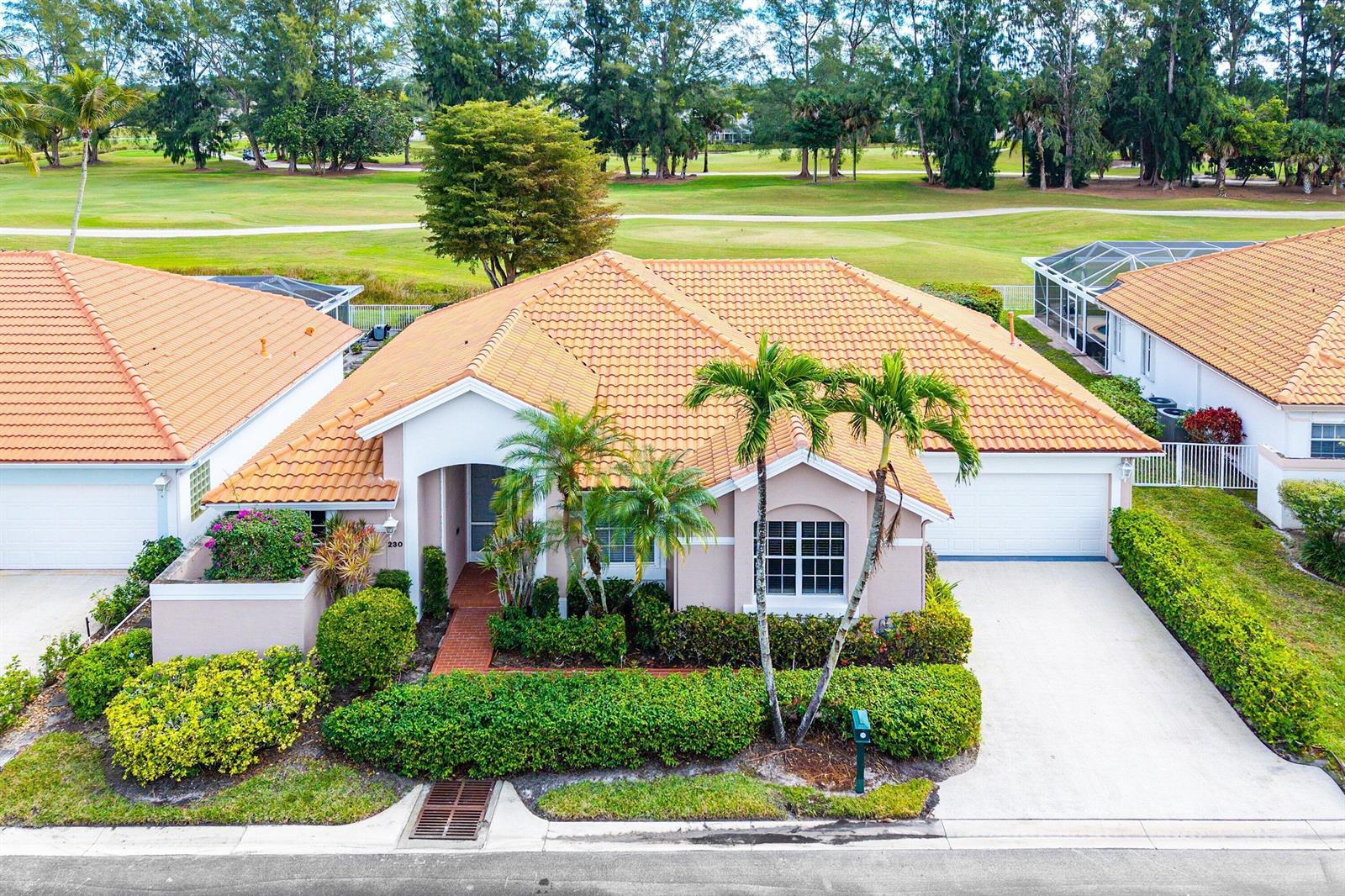 An aerial view of a single-story house with a tile roof and a golf course — 230 Eagleton Estate Boulevard, Palm Beach Gardens FL 33418, PALM BEACH GARDENS, FL