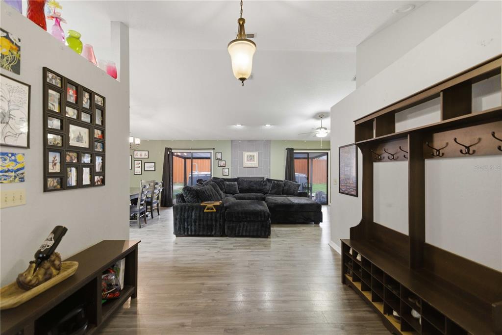 A view from an entryway looking into a living room with wood-look flooring — 86 PECAN DRIVE, OCALA, FL