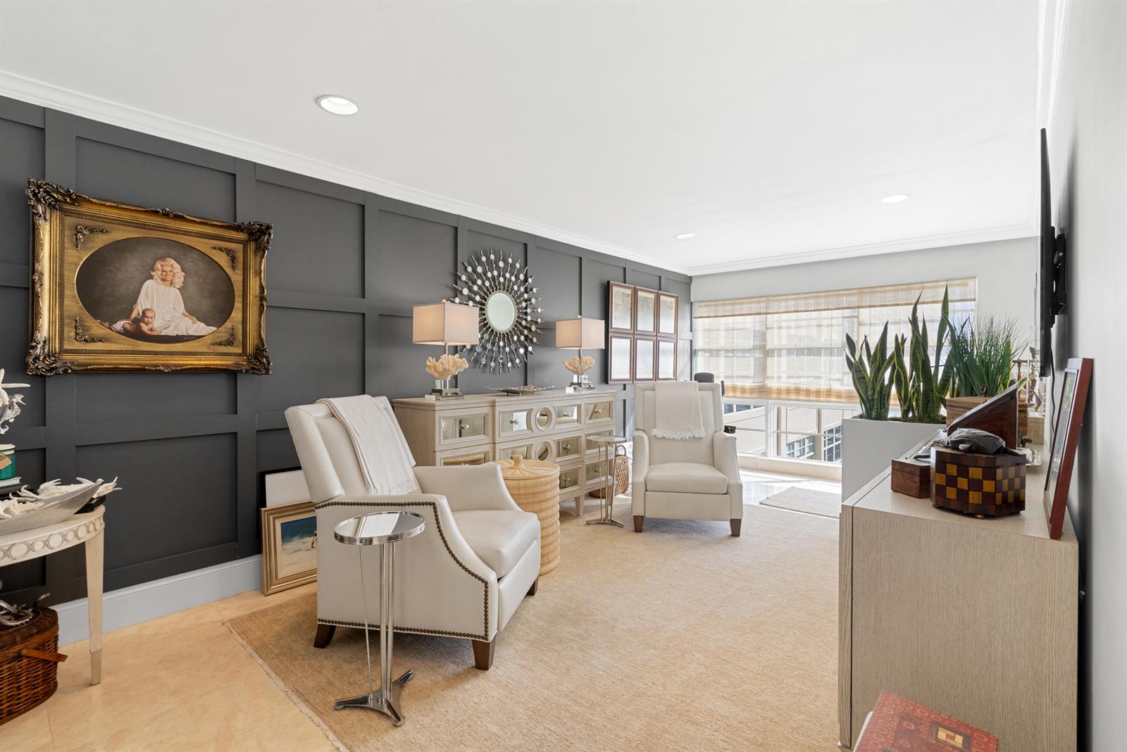 A living room features dark paneled walls, two white armchairs, and a mirrored console table — 3851 N Ocean Boulevard # 308, Gulf Stream FL 33483, GULF STREAM, FL